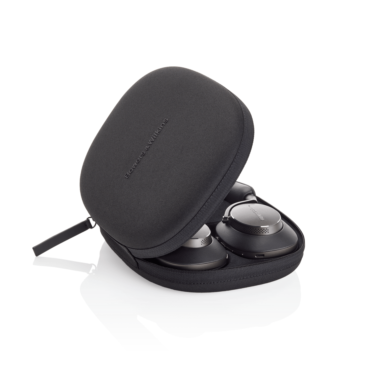 Black carrying case with wireless earbuds inside on a white background