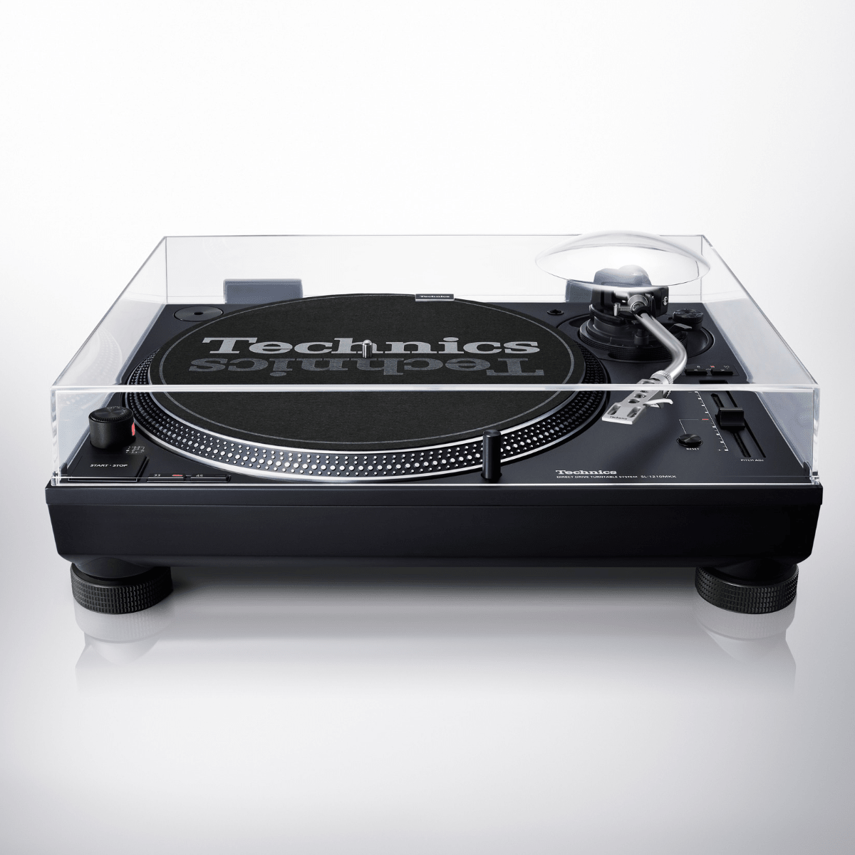 Front view of the Technics SL-1210MKX turntable with its clear dust cover closed over the platter, Technics slipmat and tonearm, on a light grey background.