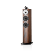 Wooden floor-standing speaker with a white background