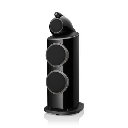 Black cylindrical speaker with three circular ports on a white background