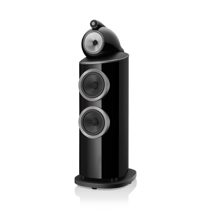 Black speaker with three circular drivers on a white background