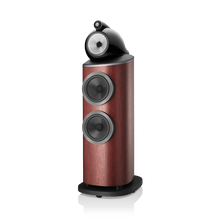 Wooden speaker with black and silver components on a white background