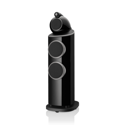 Black cylindrical speaker with multiple circular design elements on a white background