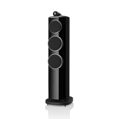 Black cylindrical speaker with three circular design elements on a white background