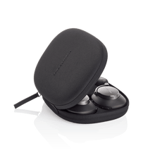 Black carrying case with wireless earbuds inside on a white background