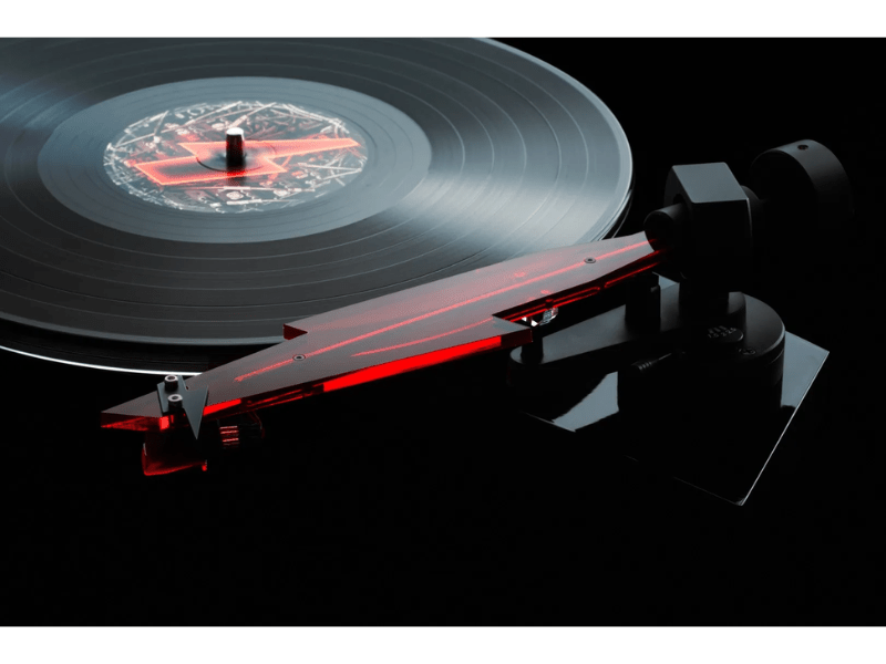 Vinyl record on a turntable with red accents on a black background