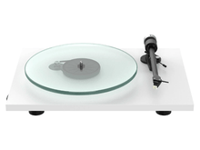 Turntable with glass platter and black arm on a white background