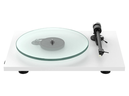 Turntable with glass platter and black arm on a white background
