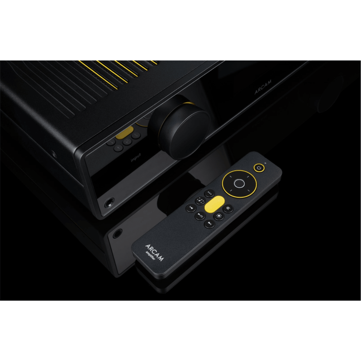 Arcam A50 Signature amplifier with included remote control, close up of input dial and top vents