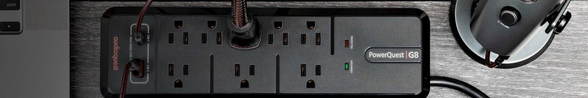 Power strip with multiple outlets on a metallic surface
