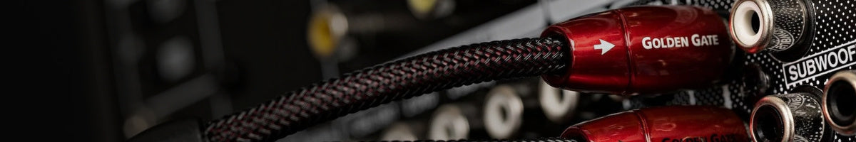 Close-up of a red audio cable with 'Golden Gate' branding on a blurred background.