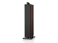 Tall black speaker with wooden accents on a white background