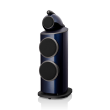 Blue and black cylindrical speaker on a white background
