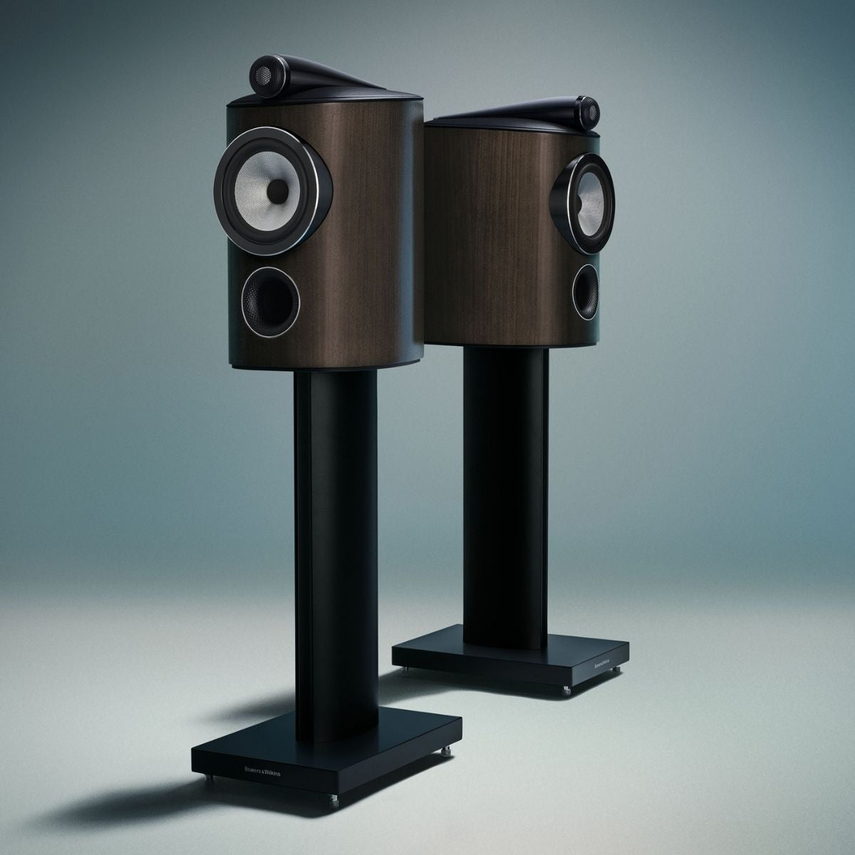 pair of dark walnut bowers wilkins 805 d5 speakers on blue background