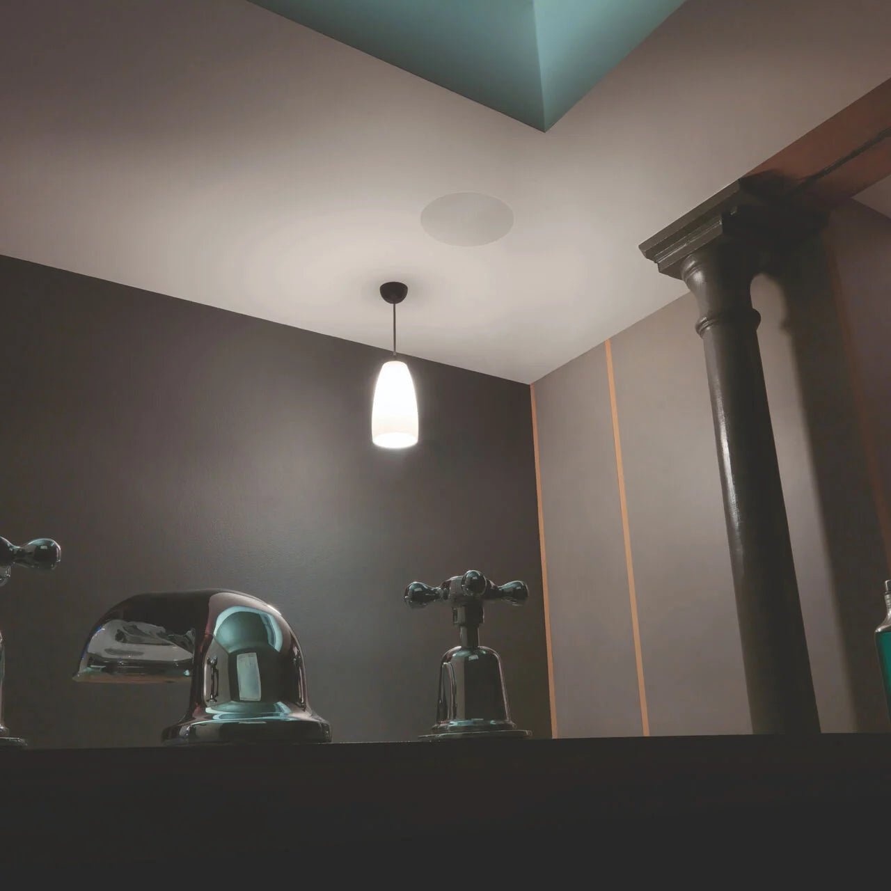 Bathroom fixtures with a light fixture on the wall
