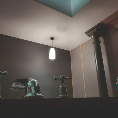 Bathroom fixtures with a light fixture on the wall