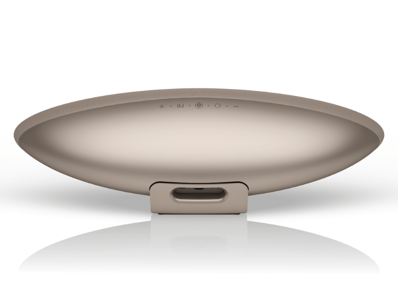 Round metallic object with a reflective surface on a white background