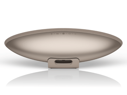 Round metallic object with a reflective surface on a white background