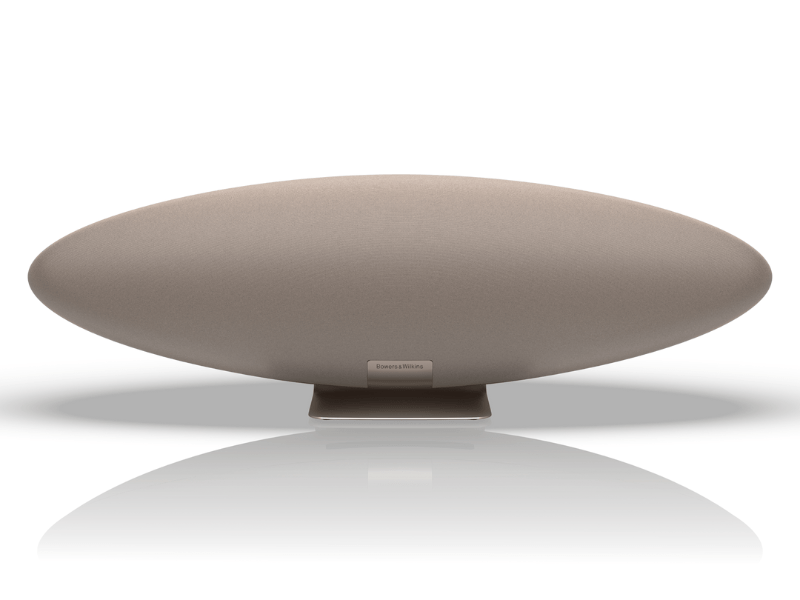 Round beige object with a reflective surface on a white background