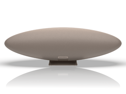 Round beige object with a reflective surface on a white background