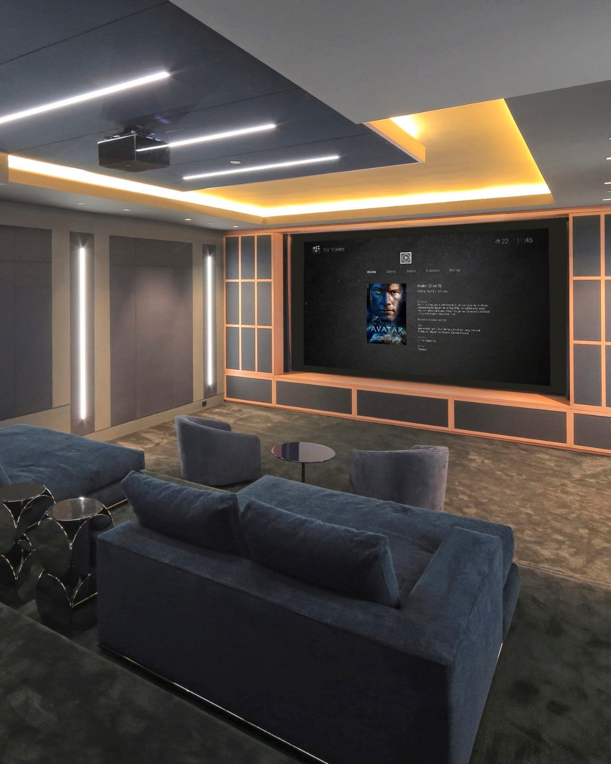 a home theatre with a blue couch and a giant screen