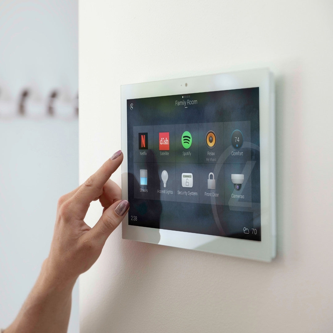 white framed control4 touch framed mounted on the wall with apps on screen