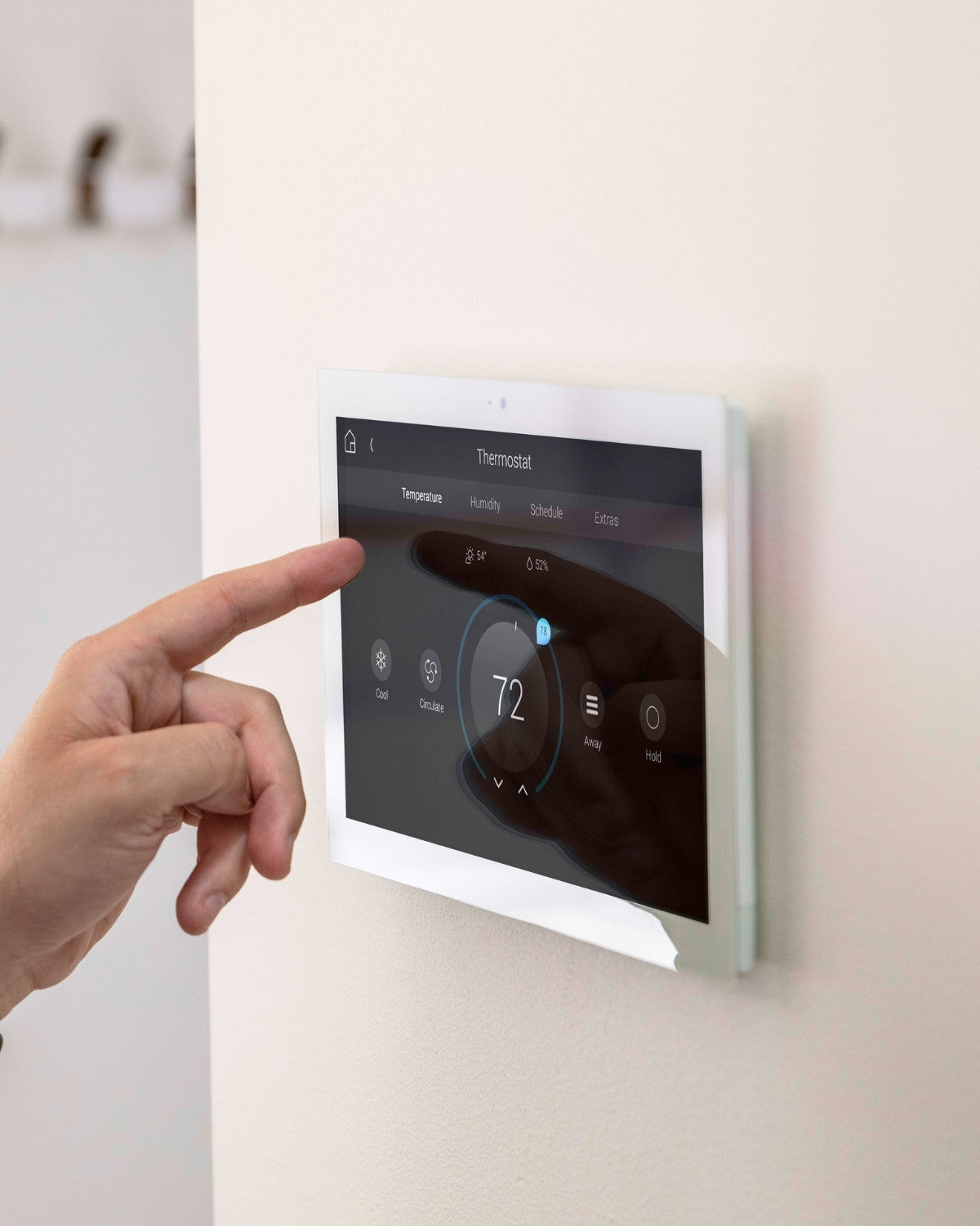 thermostat on a wall with touch screen from control4