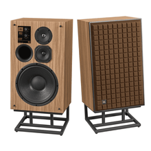 JBL L100 Classic 80 Anniversary Edition speaker pair on JS-150 floor stands, one without grille showing drivers and one with brown Quadrex foam grille