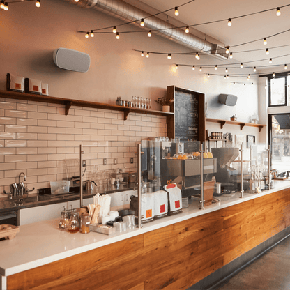 Monitor Audio CL2 M Climate Series 3G Outdoor On-Wall Speakers on wall in a cafe