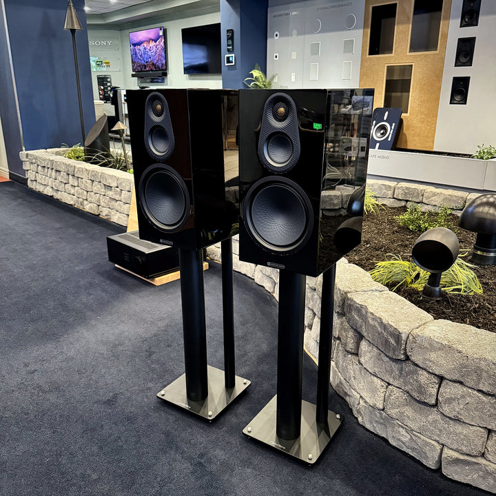 Pair of Monitor Audio Silver 8G three-way bookshelf speakers in gloss black on black stands in the Trutone showroom