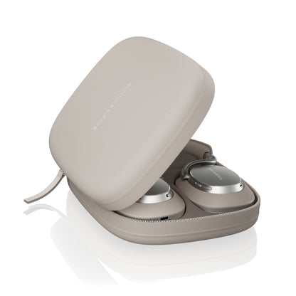 Beige carrying case with wireless headphones on a white background