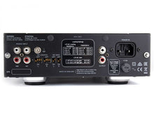 Back view of an audio component with various connectors and labels on a white background