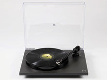 Black turntable with a clear dust cover on a white background