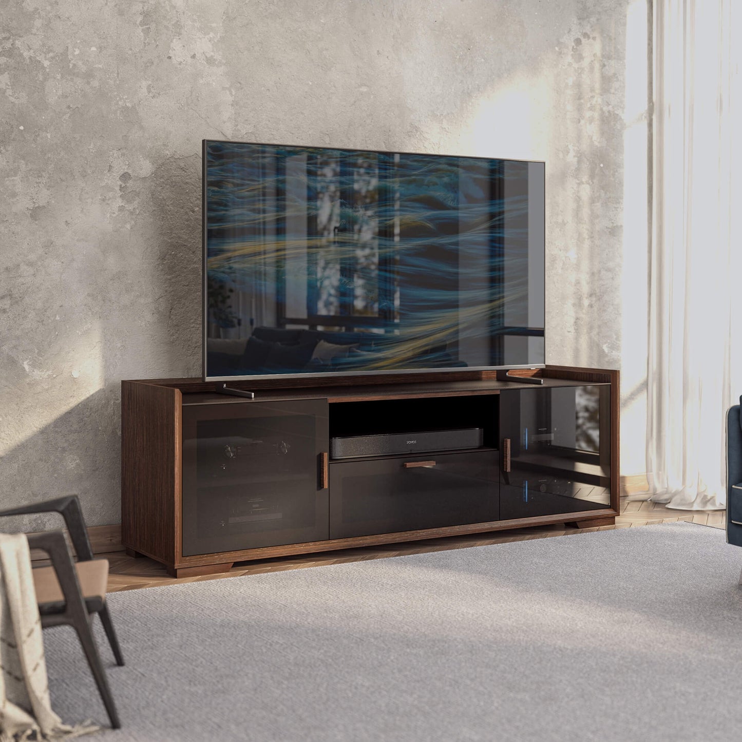 Modern TV stand with a large flat-screen TV displaying abstract art in a room with concrete walls.