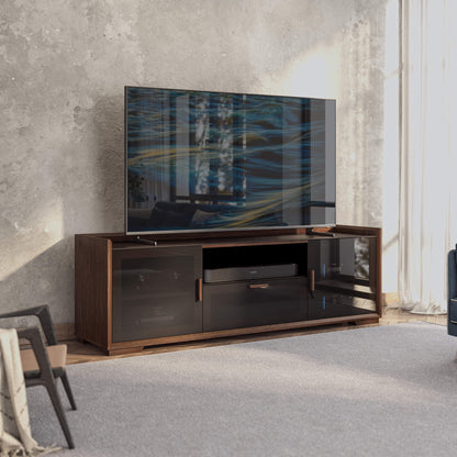 Modern TV stand with a large flat-screen TV displaying abstract art in a room with concrete walls.