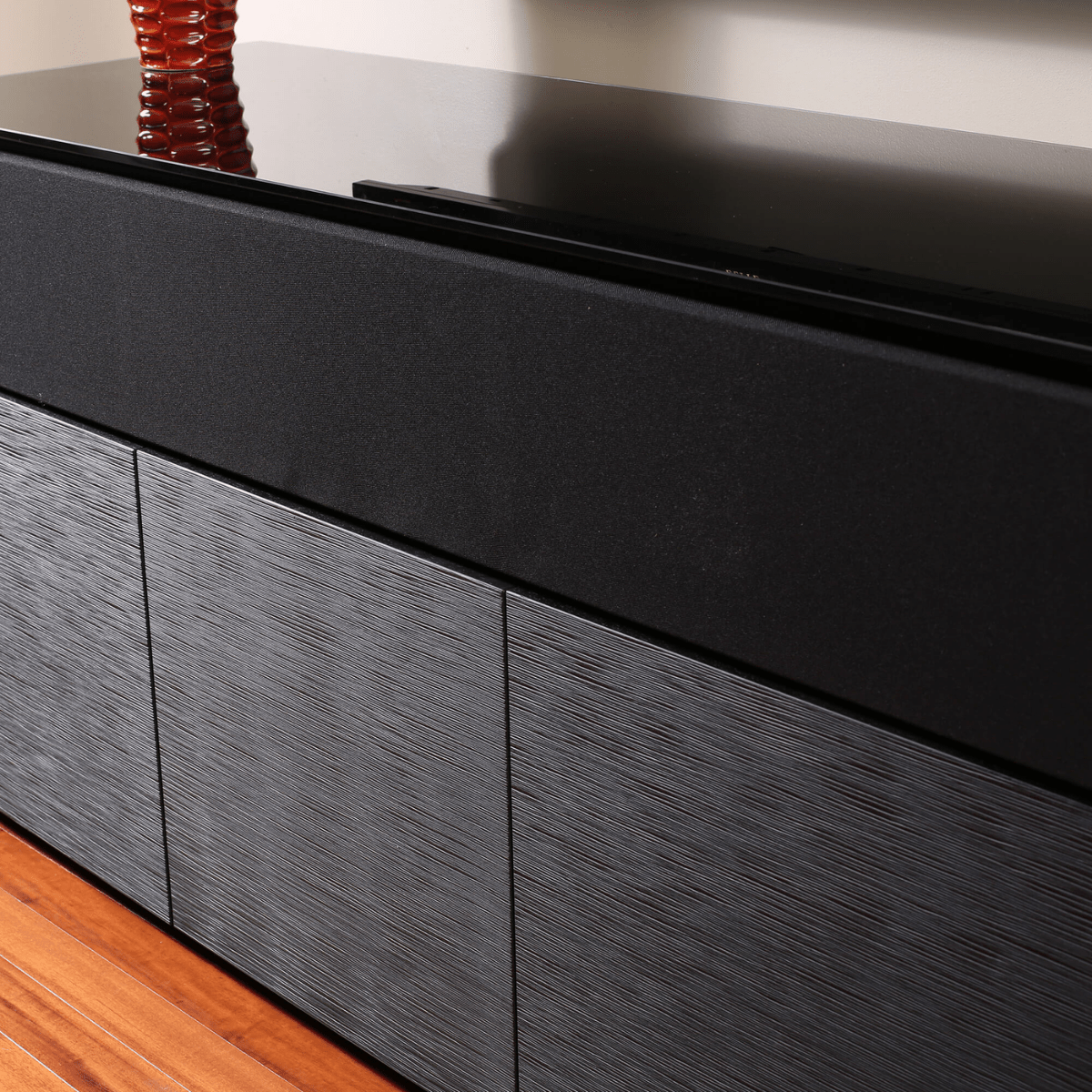 Black and gray wooden cabinet with a reflective surface
