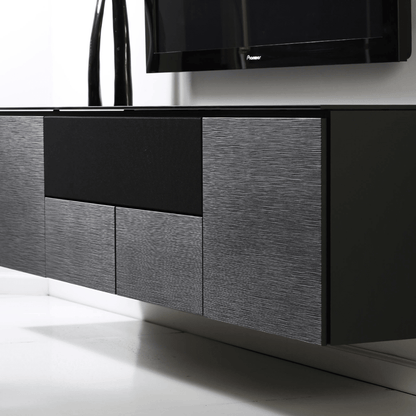 Modern entertainment console with a television mounted on a white wall.