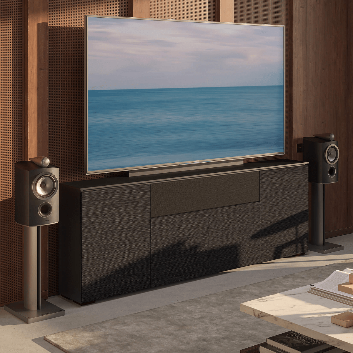Modern home theater setup with a large TV displaying an ocean scene, flanked by two speakers.