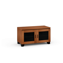 Wooden entertainment console with glass doors on a white background