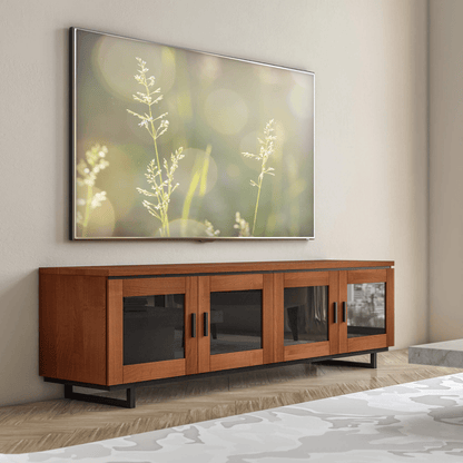 Wooden TV stand with a large screen displaying nature-themed wallpaper in a room.