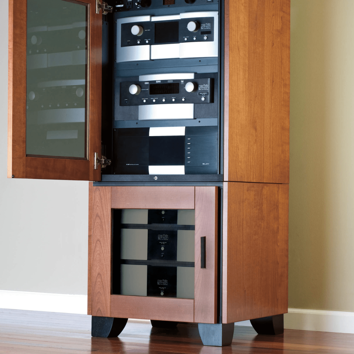 Wooden audio equipment cabinet with open door revealing audio components.
