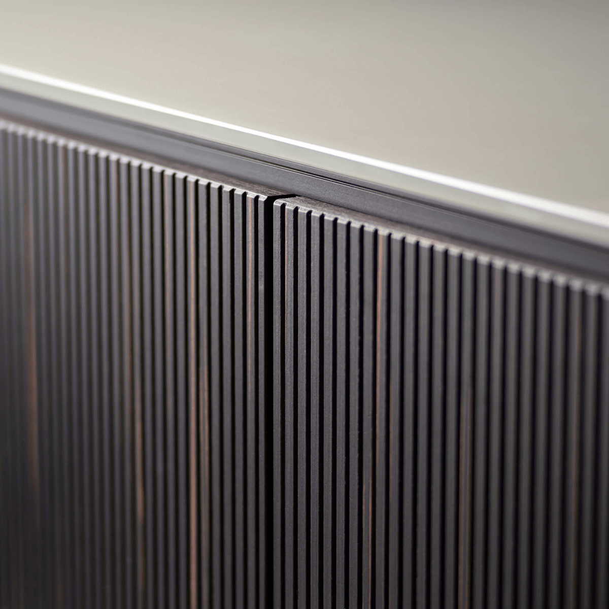 Close-up of a modern radiator against a neutral wall.