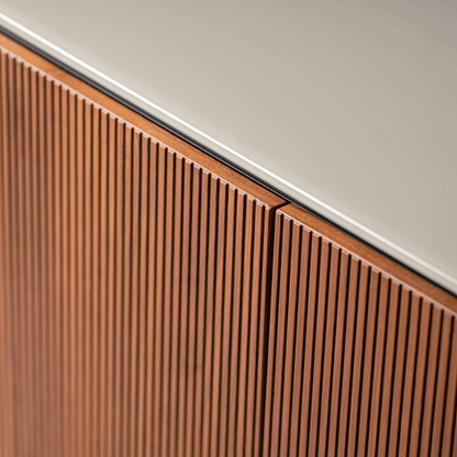 Close-up of a wooden panel with a white baseboard