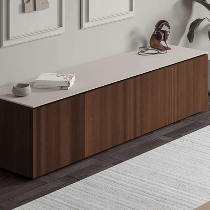 Long wooden cabinet with a white countertop in a modern room.