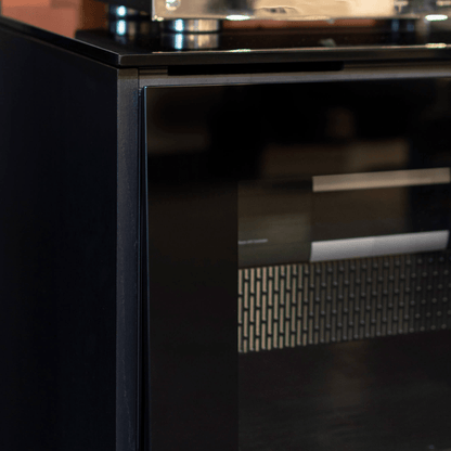 Close-up of a black appliance with metallic handle