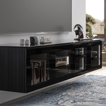 Black entertainment console with electronic devices in a living room setting
