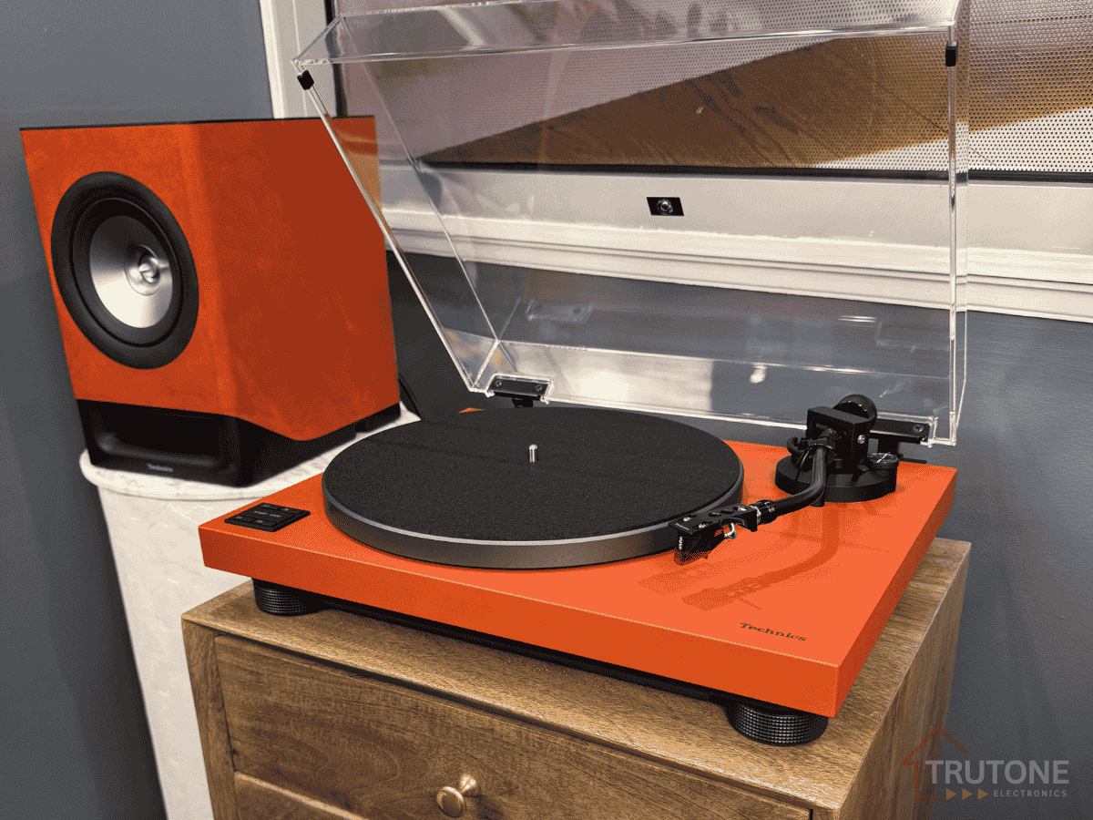 Techics SL-50CP Orange Turntable - lifetyle image with speaker